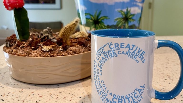 A Create Change mug filled with coffee