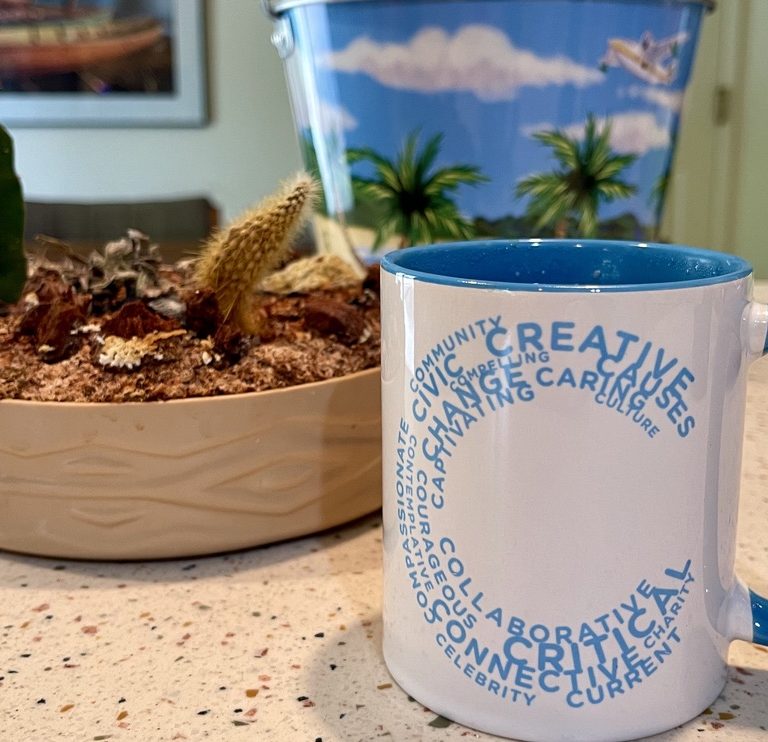 A Create Change mug filled with coffee